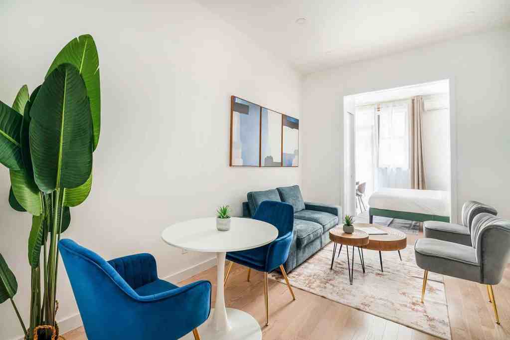 Bright living room with colorful chairs and a cozy sofa in a serviced apartment.