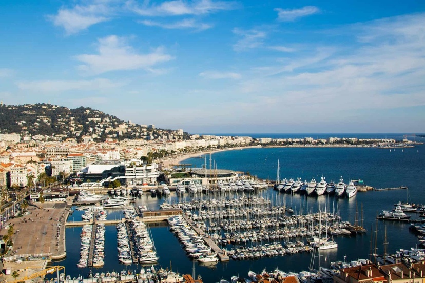 Marina in Nice, French Riviera with yachts and scenic coastline.