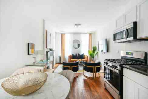 Bright and spacious living room in a serviced apartment with modern decor.