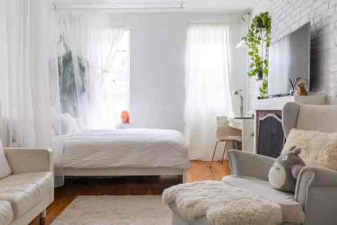 Bright and airy Chelsea studio with white decor and cozy furnishings.