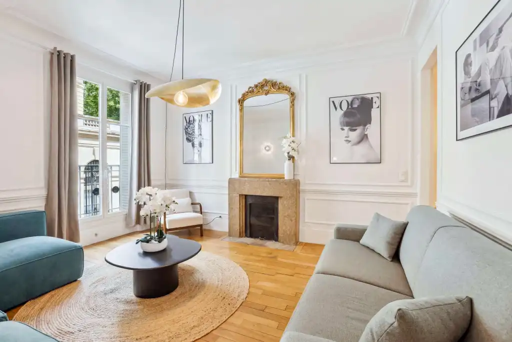 Stylish living room with modern decor and classic fireplace in Paris.