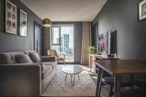 Contemporary living room in a serviced apartment with city view.