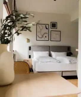 Contemporary bedroom with minimalist design and abstract wall art.