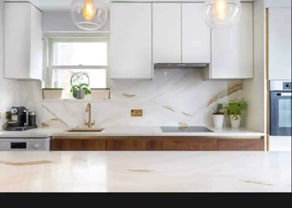 Contemporary kitchen with white cabinets, marble backsplash, and wooden accents.