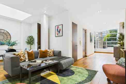 Bright and spacious living room with contemporary decor and large windows.