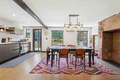 Spacious dining room with modern decor and large windows in Harlem Terrace Villa.