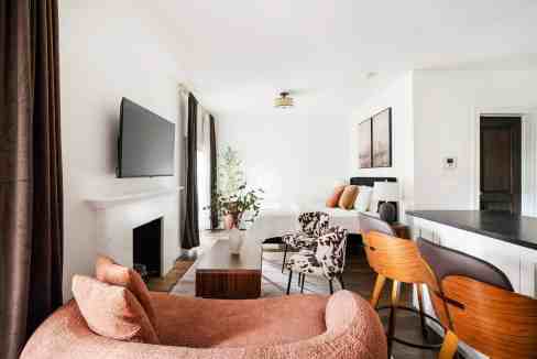 Modern living room with cozy seating, TV, and elegant decor in Greenwich Village apartment.