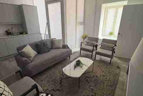 Stylish living room with modern furniture and natural light at Edgewood Mews.