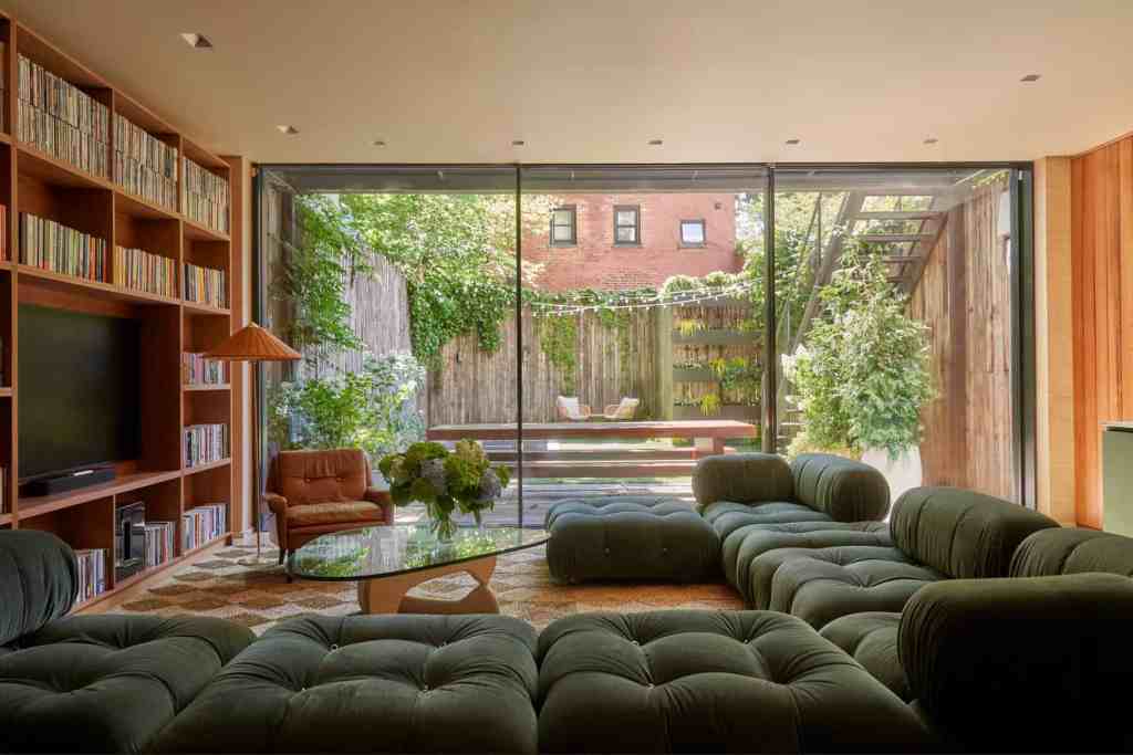 Stylish living room with large glass doors opening to a garden.