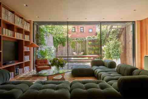Stylish living room with large glass doors opening to a garden.