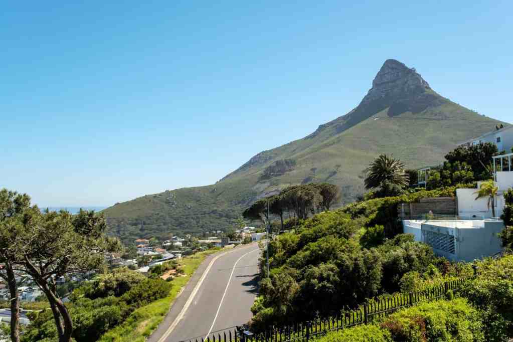 Beautiful view of Camps Bay with mountain and coastal road.