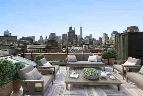 Rooftop lounge with city skyline view at Spring Street Penthouse.