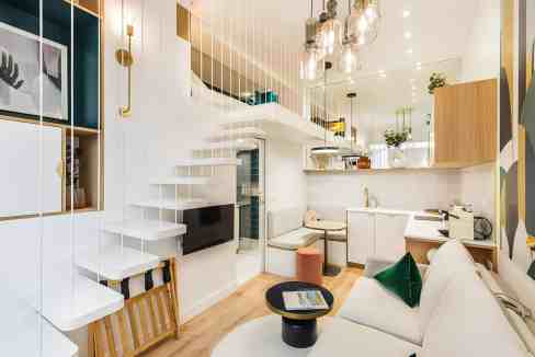 Stylish and cozy serviced apartment with open-plan living area and modern decor.