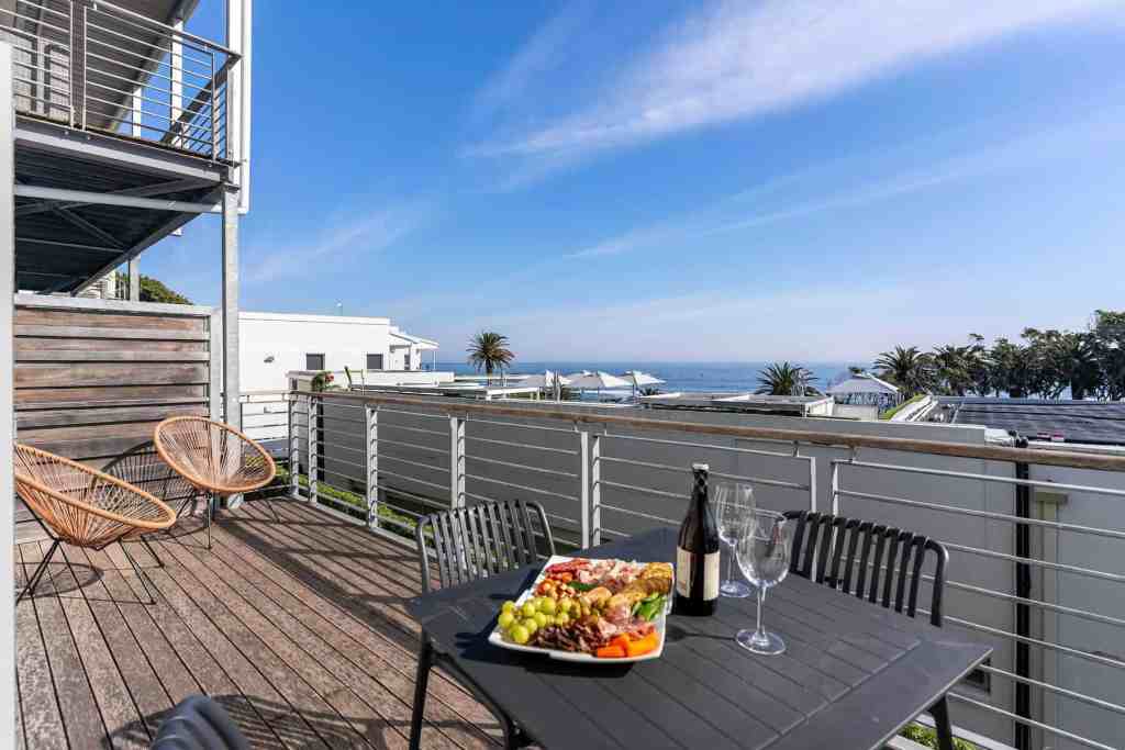 Outdoor dining area with ocean view at Caprice Coastal Court serviced apartment.