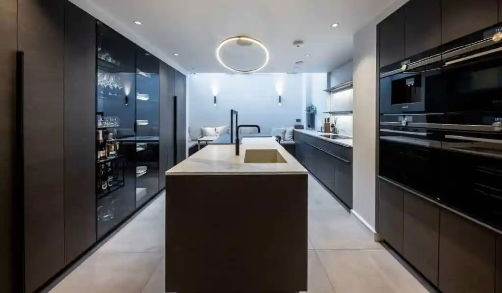 Contemporary kitchen with sleek black cabinetry and central island in Belgravia Emery.