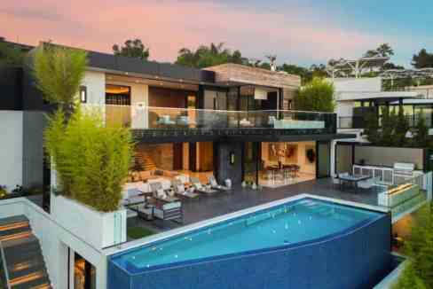 Contemporary villa with infinity pool and outdoor lounge area.