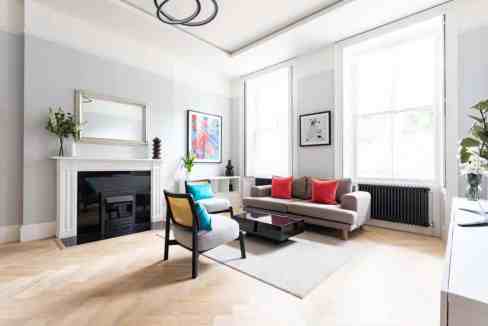 Bright and stylish Marylebone Georgian living room with modern decor and large windows.