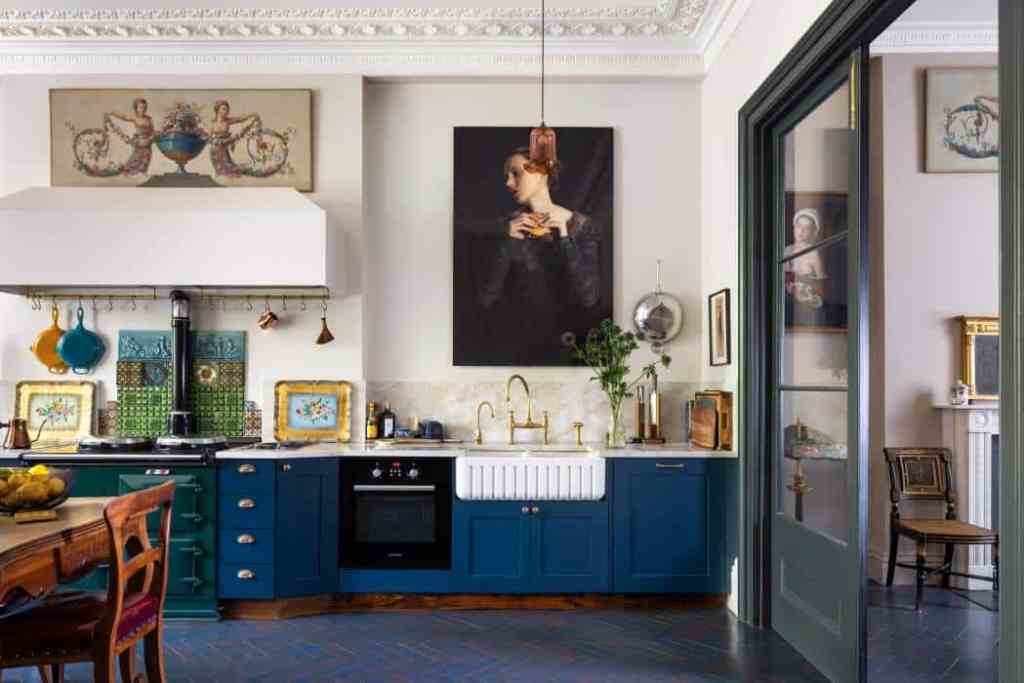 Stylish kitchen with blue cabinets, artwork, and modern decor.