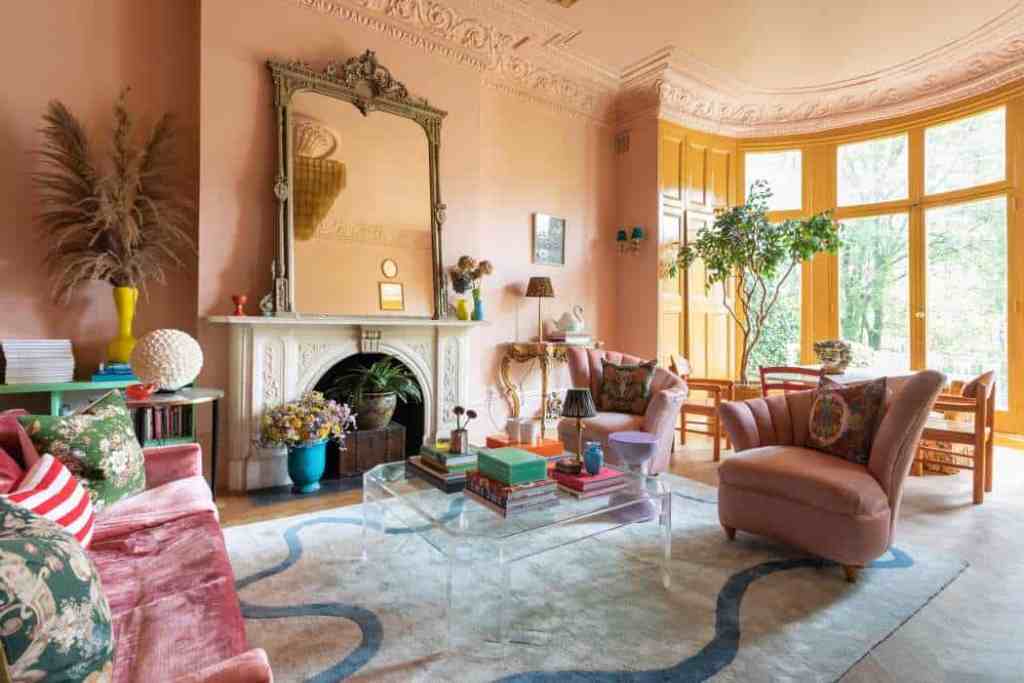 Stylish and cozy living room with vintage decor and large windows.
