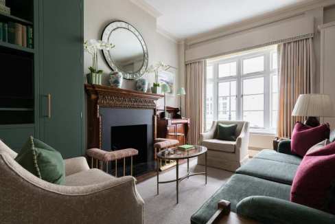 Stylish and cozy living room with classic decor and large window.