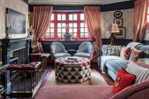 Stylish living room with vintage decor and large bay windows in South Kensington.