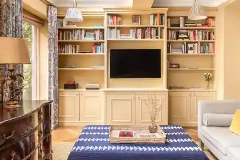 Stylish living room with built-in bookshelf and cozy seating area.