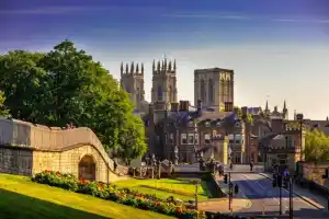 York cityscape with historic cathedral and lush park in the foreground.