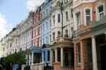 Colorful Victorian townhouses in Notting Hill, London, with ornate facades.