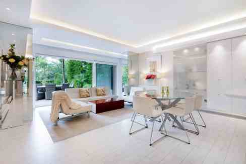 Bright, modern living room with large windows and stylish furniture in Hampstead White Garden.