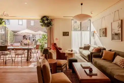 Modern living room with comfortable sofas and large windows at Wilde Cambridge Courtyard.