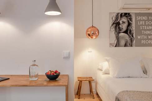 Cozy bedroom with minimalist decor and stylish wall art.