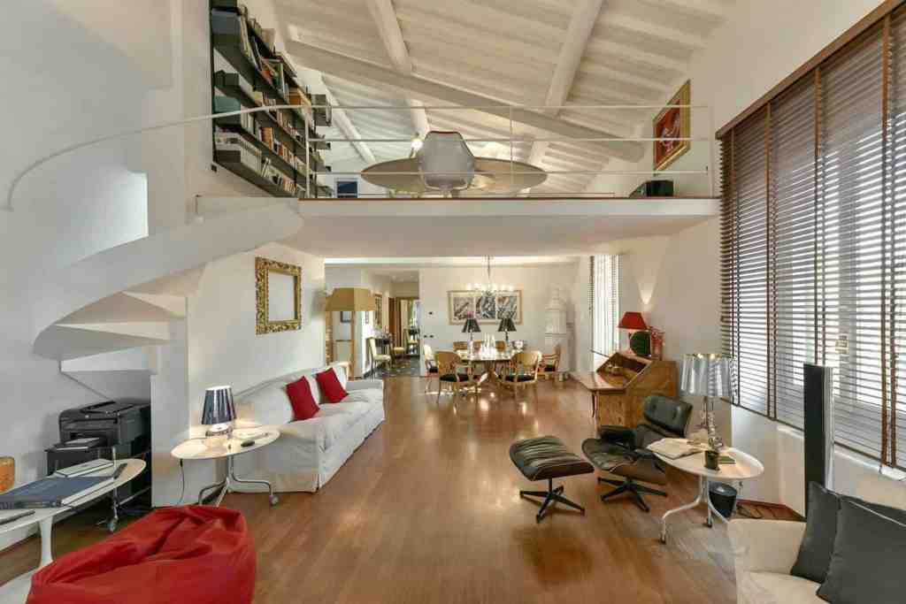 Spacious living room with modern decor and high ceilings at Palazzo Giorgina Penthouse.