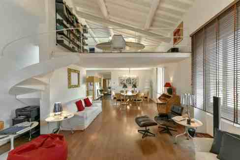 Spacious living room with modern decor and high ceilings at Palazzo Giorgina Penthouse.