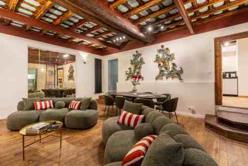 Stylish living room with modern furniture and wooden ceiling.