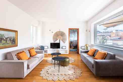 Bright and stylish living room with modern decor and large windows.