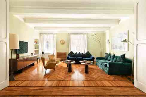 Spacious living room with vintage furniture and natural light in Roman Opulence Retreat.