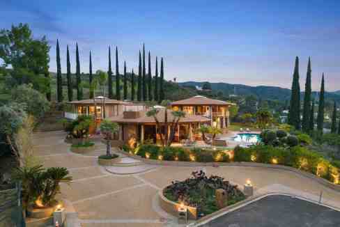 Luxury estate with pool and tall cypress trees in Encino, California.