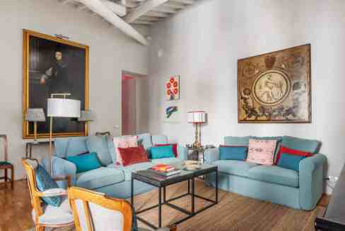 Stylish living room with modern art, comfortable sofas, and decorative cushions.