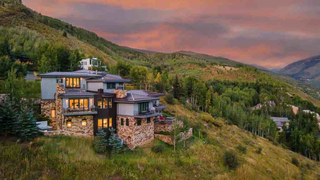 Modern mountain home with expansive views in Vail Valley at sunset.