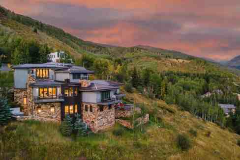 Modern mountain home with expansive views in Vail Valley at sunset.