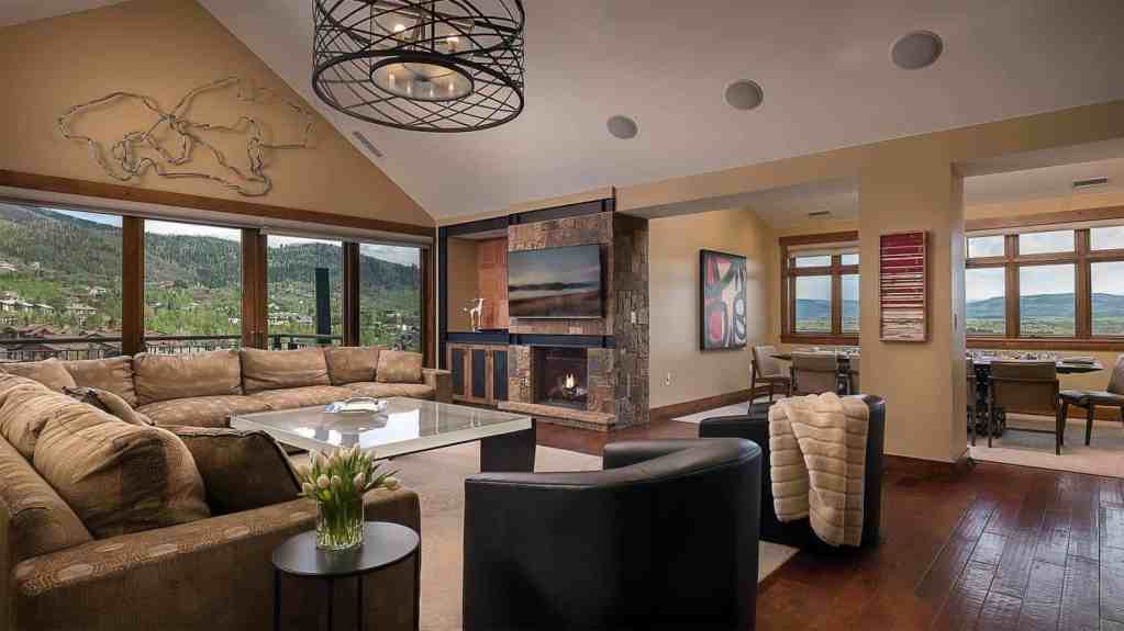 Spacious living room with mountain views, modern decor, and cozy seating.
