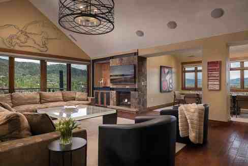 Spacious living room with mountain views, modern decor, and cozy seating.