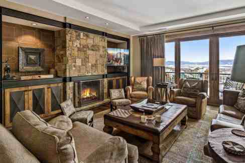 Elegant living room with mountain views and cozy fireplace.