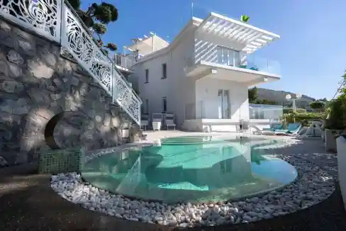 Modern coastal villa with private pool and scenic mountain views.