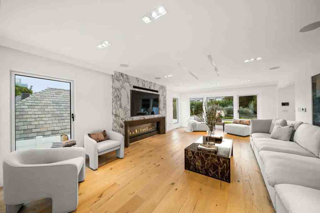 Spacious modern living room with white furniture and large windows in Sunset London Villa.