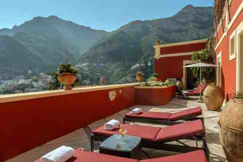 Terrace with sun loungers and mountain view at Gilded Amalfi Villa.