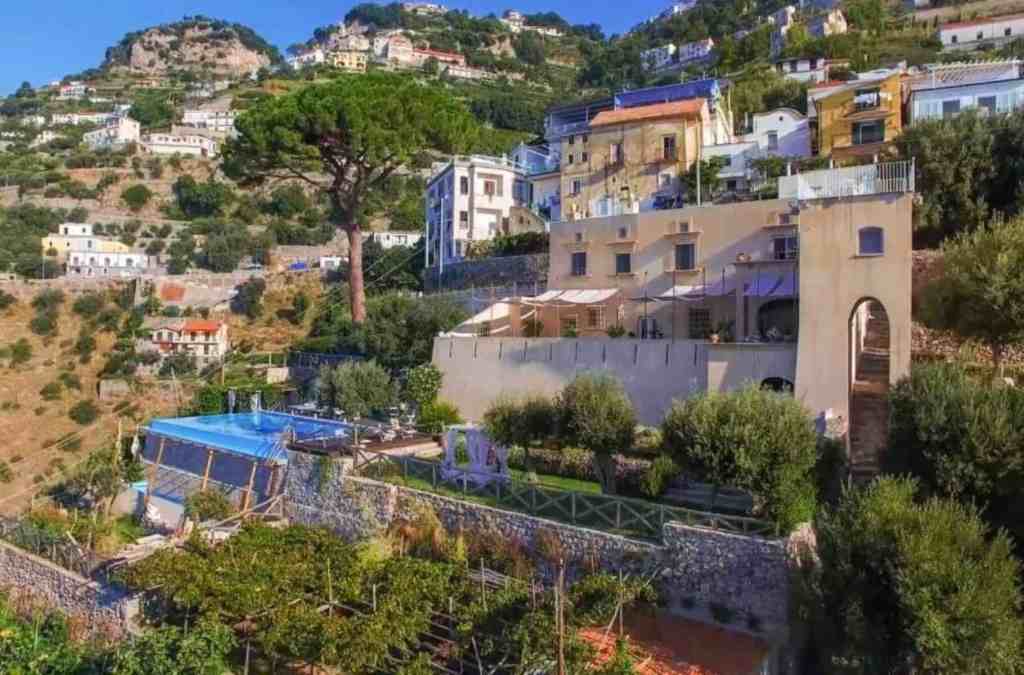 Coastal hillside villa with lush greenery and scenic ocean views in Nocerino.