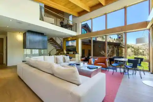 Spacious living room with large windows and modern furniture at Vail Fairway Lodge.