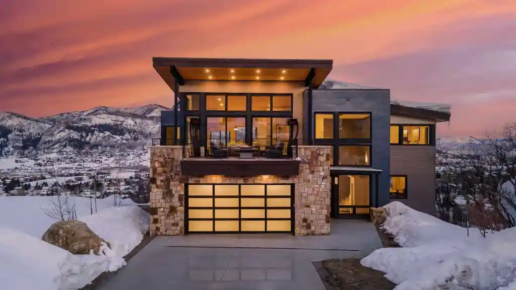 Modern serviced apartment with mountain views and snow-covered landscape.