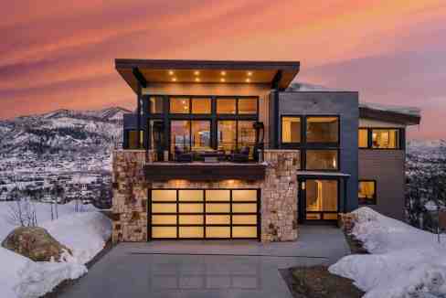 Modern serviced apartment with mountain views and snow-covered landscape.